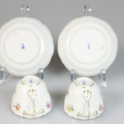 Een porseleinen kop-en-schotel met daarbij gevoegd twee schoteltjes, alle met bloemendecor. Meissen, 1e helft 20e eeuw.