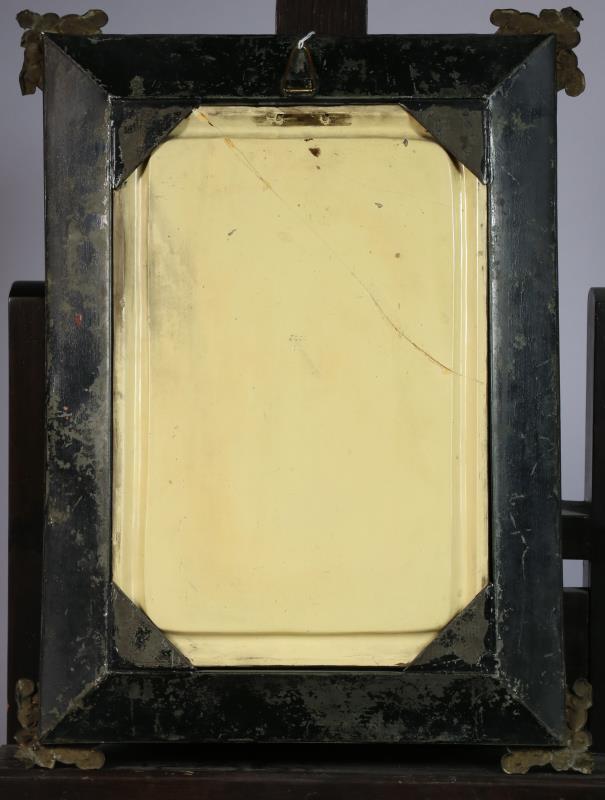A cast relief in the shape of a lady in a copper frame. Circa 1900.
