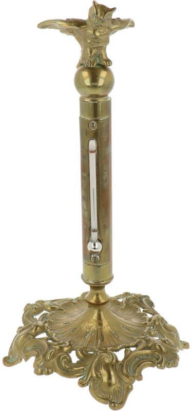 Een bureauthermometer met daarop de uil van Minerva. 