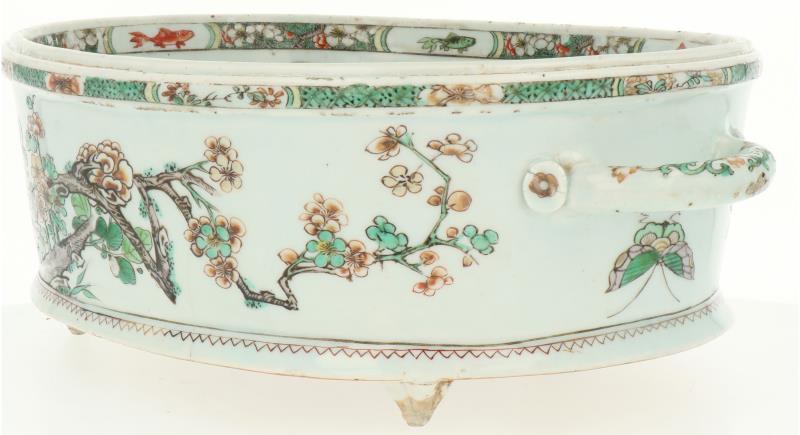 Een Famille Verte porseleinen jardinière gezet op drie voetjes met twee handvatten. China, Kangxi (circa 1700).