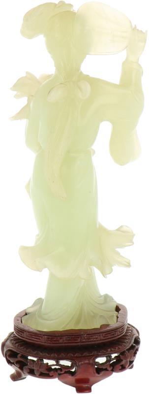 Een in jade vervaardigd figuur in de vorm van een Chinese vrouw met waaier en bloem, incl. sokkel. China, 19e/20e eeuw.