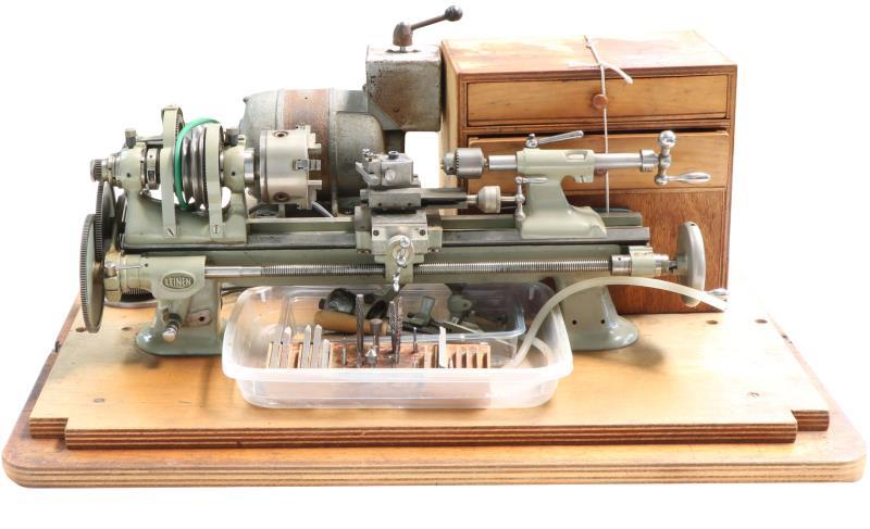 Een Klokkenmakers draaibank, Tot +/- 50 jaar geleden gebruikt in de instrumentmakerij van Nonius Delft Holland thans Enraf Nonius Rotterdam. Diverse hulpstukken, set spantangen (ook kom-spantangen) en draaibeiteltjes. Leinen Duitsland, midden 20e eeuw.