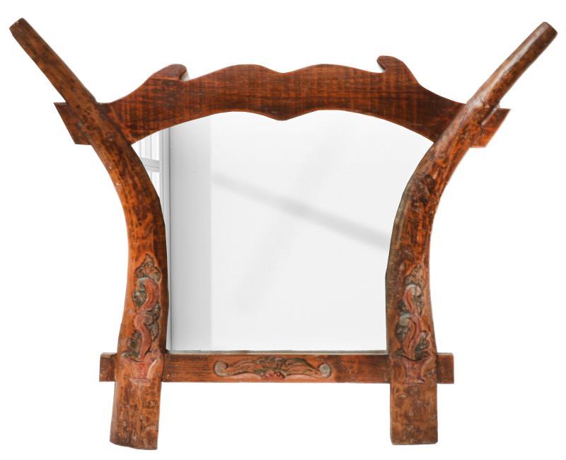 Een wandspiegel vervaardigd van een Indonesische ploeg.