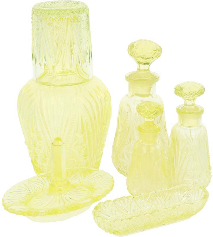 Een lot van zes diverse glazen objecten w.o. drie parfumflesjes, ringenhouder, karaf, waterglas en bakje, vervaardigd in uranium of annaglas. 