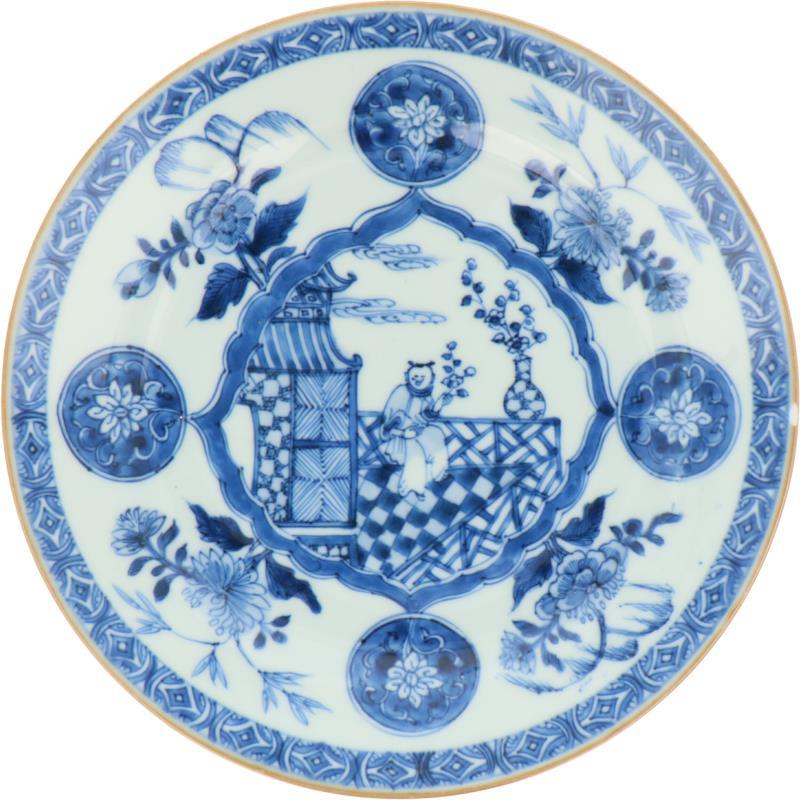 Een porseleinen bord met figuur in bloemen decor. China, 18e eeuw.