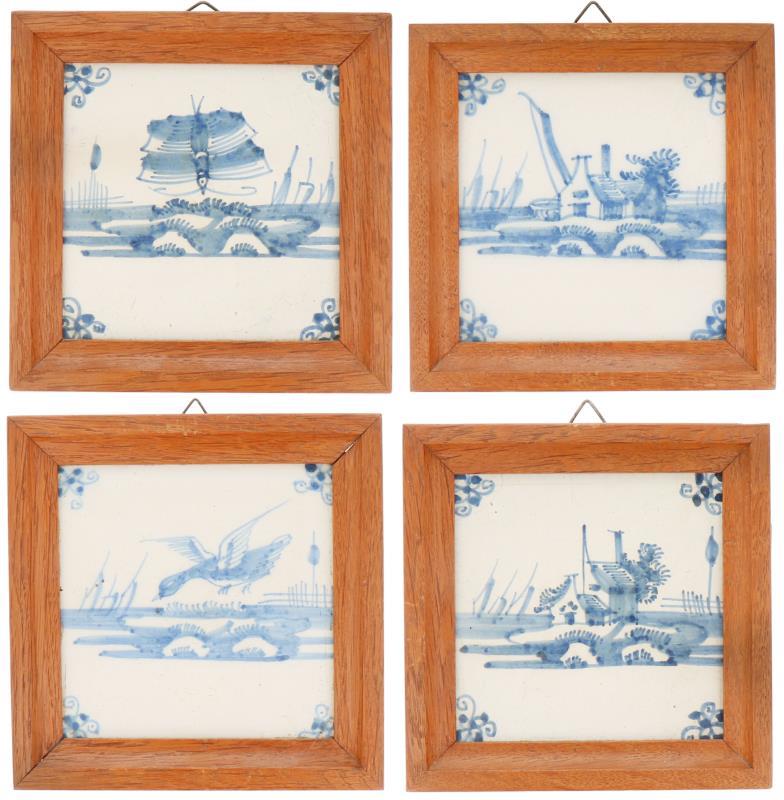 Een lot van vier aardewerk tegels in houten omlijsting. Delft, 19e eeuw.