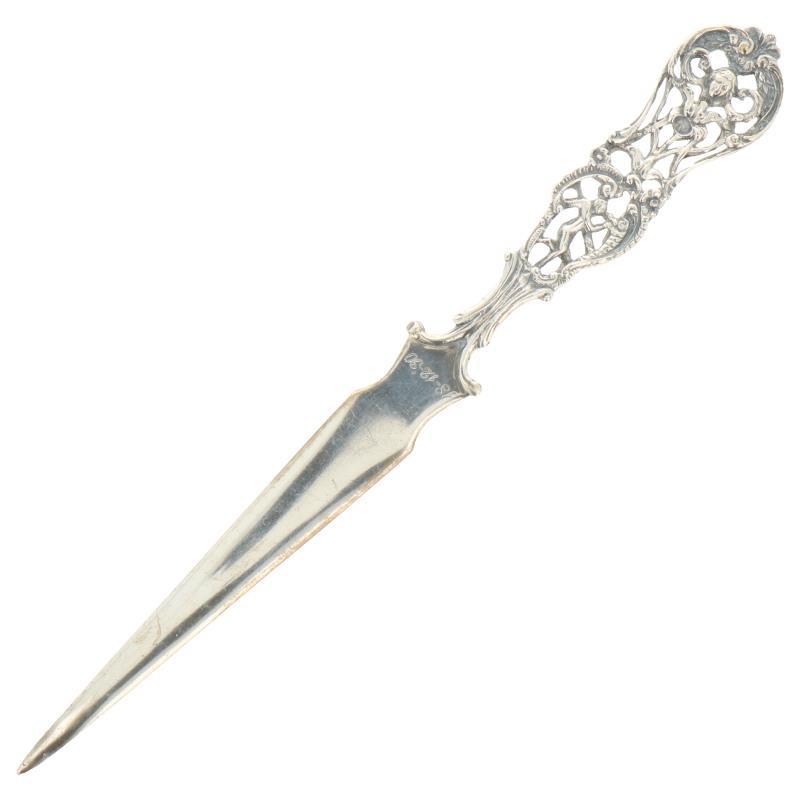 Brievenopener met biedemeier en putti versieringen zilver.