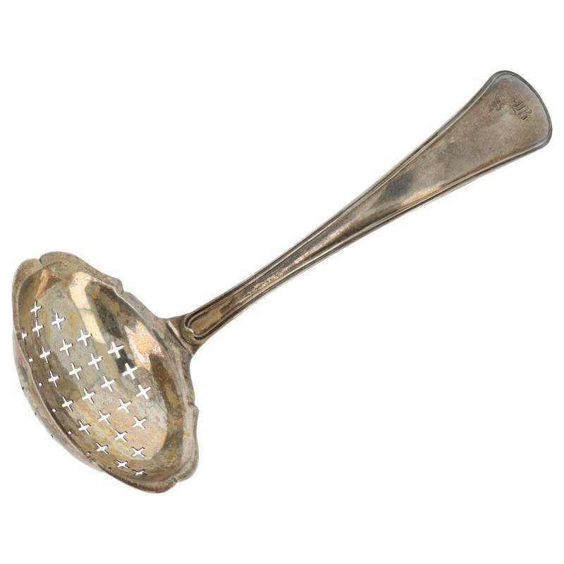 Strooilepel met opengewerkte (+) vormen zilver.