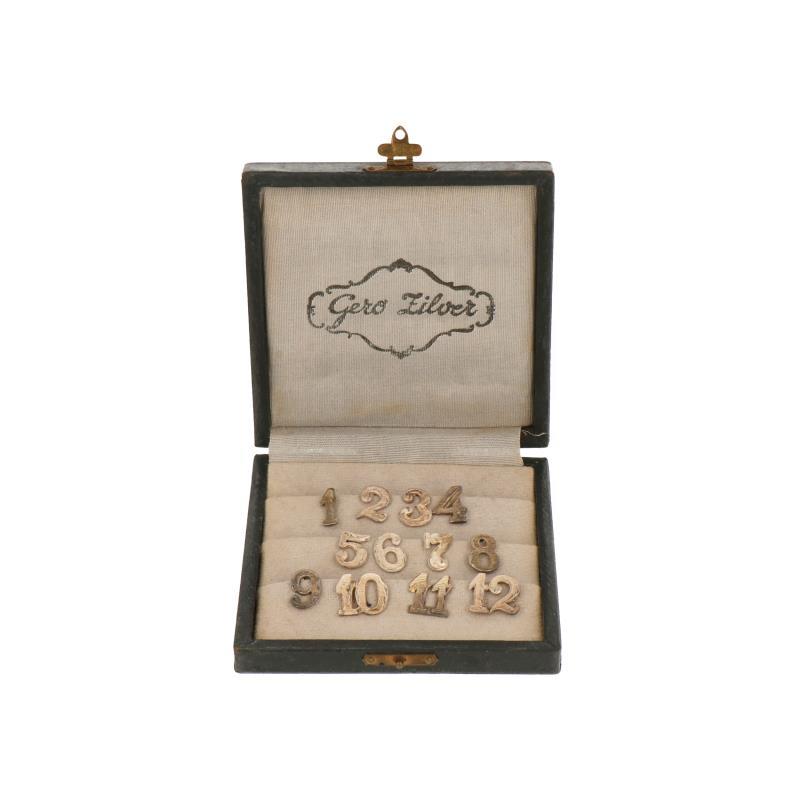 (12) Delige set tafel glas-nummers in originele etui zilver.