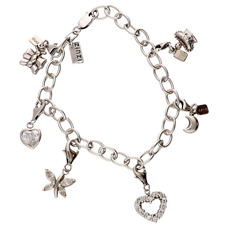 Zilveren schakel armband Zinzi met 6 hangers o.a. hart, vlinder, kroontje etc.