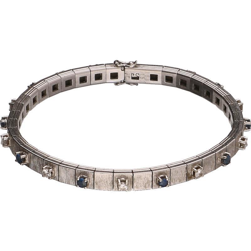 Witgouden armband bezet met 9 briljant geslepen diamanten en 10 saffieren, 18 karaat.
