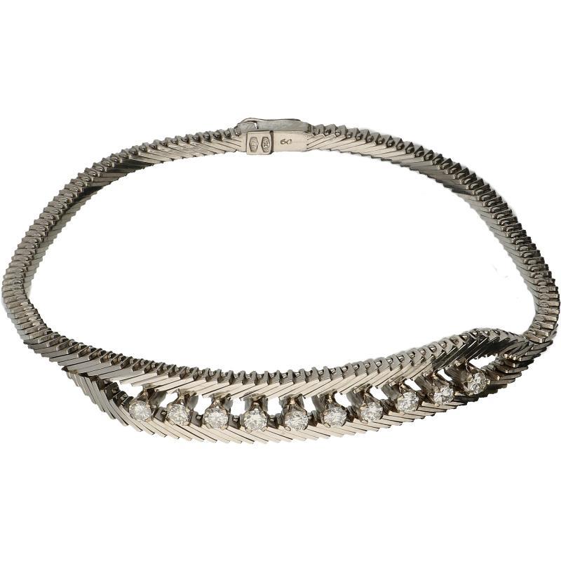 Witgouden armband met slangen schakel, bezet met 10 briljant geslepen diamanten, 18 karaat.