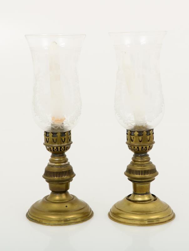 A set with (2) candles with etched glass wind lights.