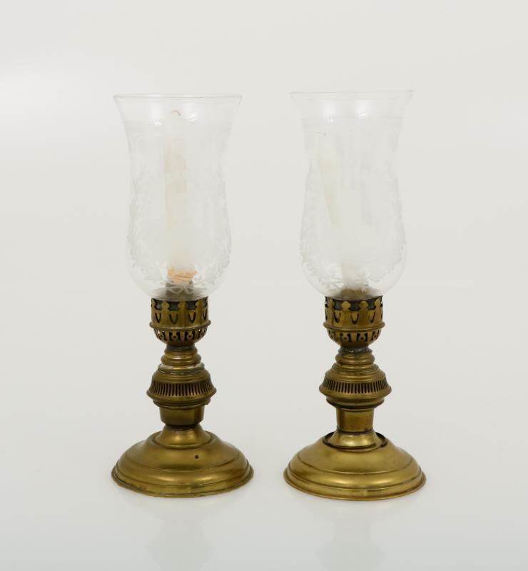A set with (2) candles with etched glass wind lights.