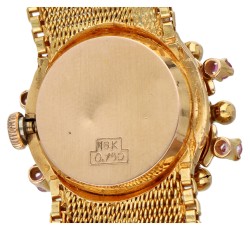 18K Geelgouden armband met horloge 'sous capot' en bezet met robijn.