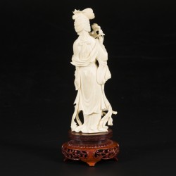 Een ivoren Guanyin op houten sokkel, China, begin 20e eeuw.