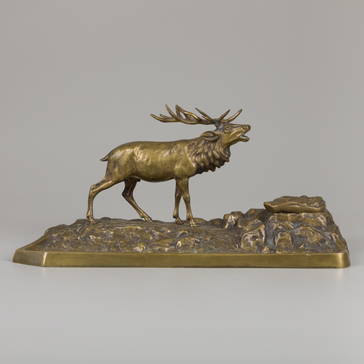 Een bronzen inktstel met pennenbak in de vorm van een edelhert op rots, ca. 1900.