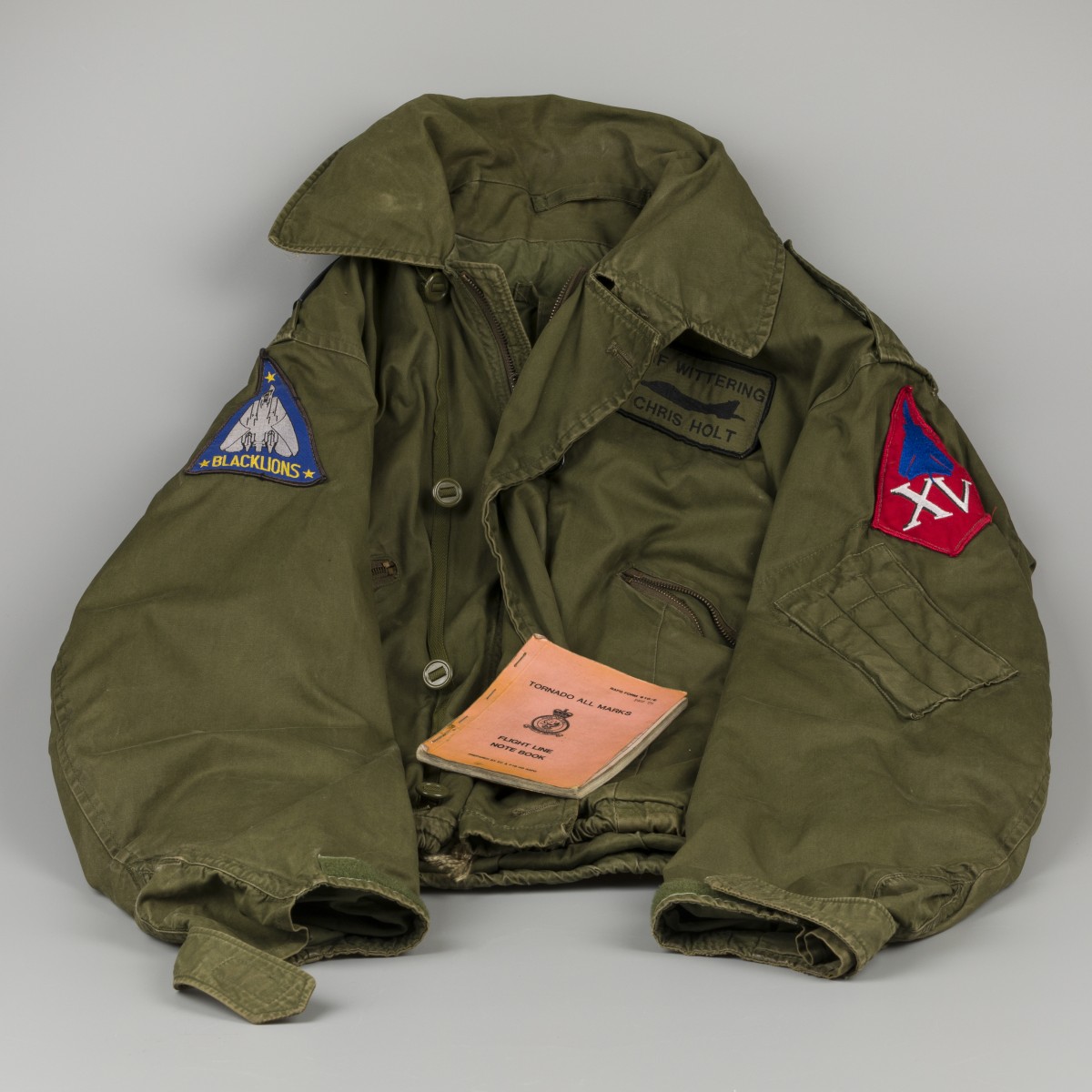 Een vliegeniersjas / bomber jacket, Black Lions, F14 Tomcat en flight line note book.