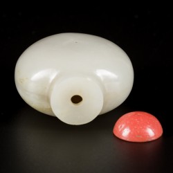 Een celadon jade snuff bottle met bloedkoralen dop, China, 19e eeuw.