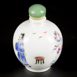 Een porseleinen famille rose snuff bottle, gedecoreerd met hoffelijkheden, China, circa 1900.