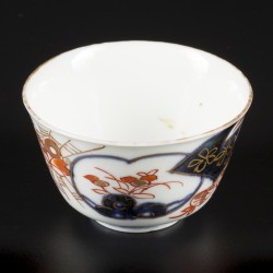 Een lot porseleinen bordjes en een kopje, alle met Imari decor. Japan, 18e eeuw.