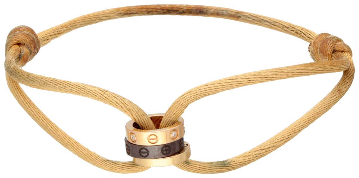 Cartier 'Love Cord' armband van beige zijden koord met drie ringen en diamant.