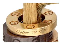 Cartier 'Love Cord' armband van beige zijden koord met drie ringen en diamant.