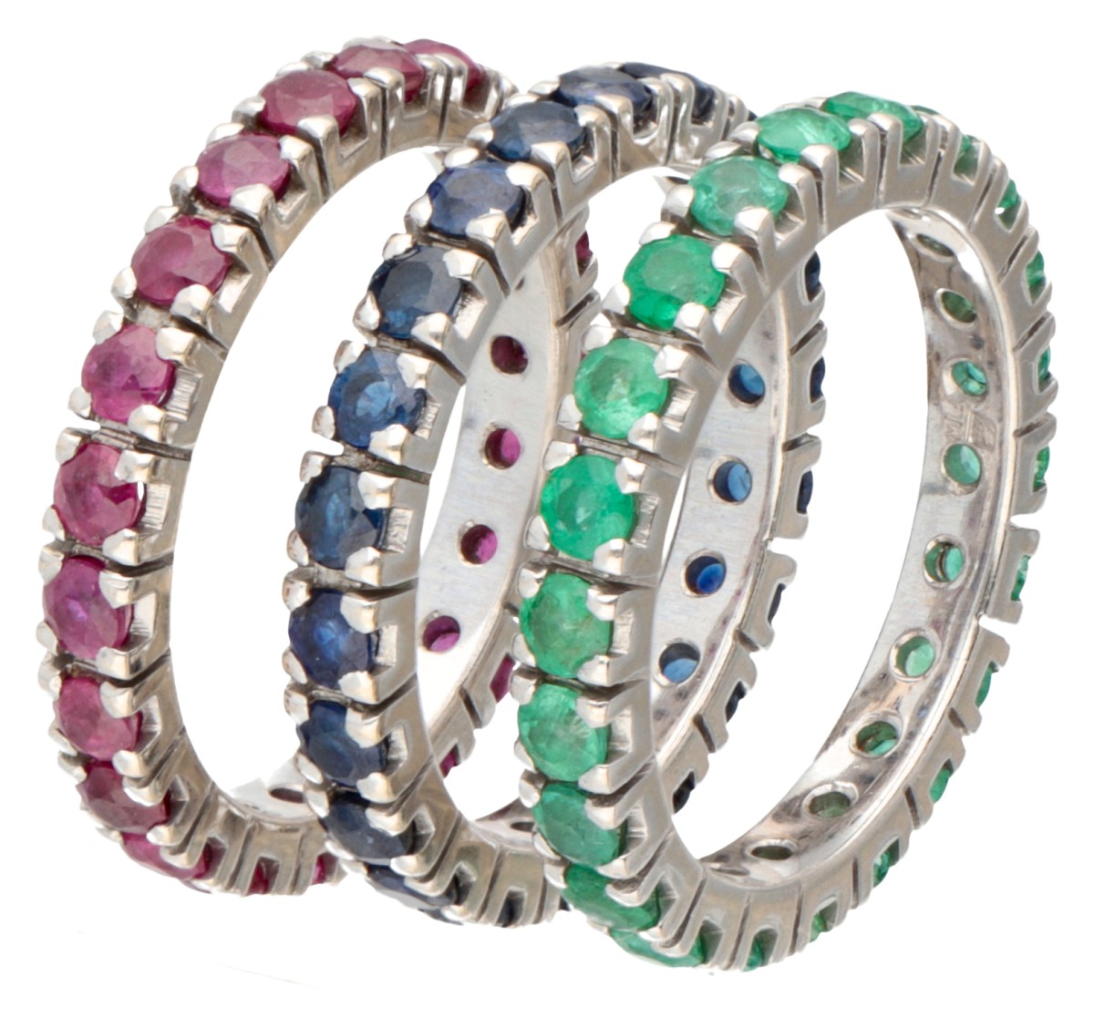 Set van drie 18 kt. witgouden eternity ringen bezet met natuurlijk robijn, saffier en smaragd.